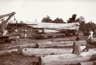 Loading a ten-ton tree trunk. A huge tree trunk, weighing 10 tonnes according to an original