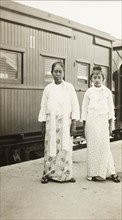 Burmese women at a railway station. Portrait of two Burmese women standing on a railway platform in