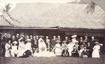 A European wedding party in Burma. Formally dressed men, women and children gather for a group