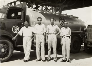 Indo-Burma Petroleum Company tanker. Four uniformed Burmese workers pose for a photograph in front