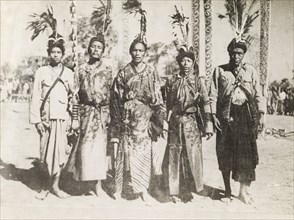 Five Asian men in ceremonial dress. Portrait of five Asian men, dressed in ceremonial attire