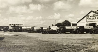 Indo-Burma Petroleum Company forecourt. Petrol tankers and company vehicles, parked on the