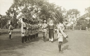 Judge Clifford Francis inspects the King's African Rifles. Judge Clifford Francis is accompanied by