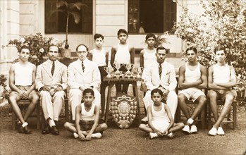 Sports team at the Royal College of Colombo. Outdoors portrait of a sports team with their trophies