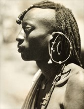 African man with a distinctive earring. Profile shot of the head and shoulders of a young African