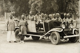 A cadre of Indian Armed Police. A cadre of uniformed Indian Armed Police assemble round a car for a