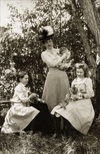 Playing with tiger cubs at Perth Zoo. Lady Annie Lawley (middle) and her daughters, Ursula (right)