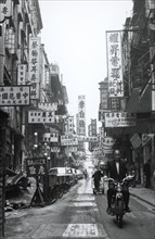 Hong Kong side street. A lively side street in the city centre crowded with signs written in