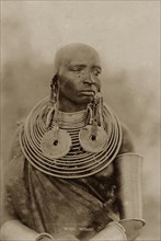 Portrait of a Maasai woman. Half-length portrait of a Maasai woman wearing numerous metal neck