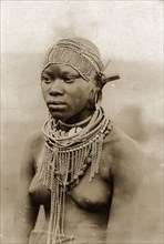 Kenyan woman in beaded headdress. Half-length portrait of a semi-naked woman wearing a beaded