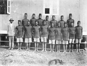 Employees of the Public Works Department. Group portrait of 17 African employees at the Public