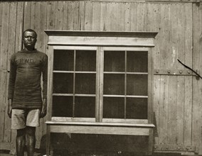 Cabinet for Empire Exhibition. An employee of the Public Works Department stands beside a cabinet