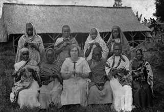 Women knitting. Group portrait of Mrs Charles Bungey and nine African women, most of whom are