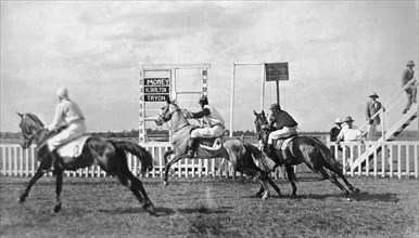 Nairobi horse race. Three horses and their European jockeys (named Money, H Tarlton, and Tryon)