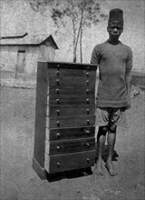 African cabinetmaker. An employee of the Public Works Department, identified in the the caption as