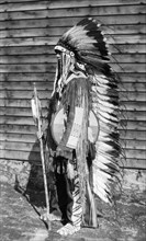 Native American costume. A European man dressed in traditional native American costume including a