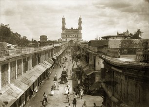 View of the Charminar. A busy street leads up to the Charminar monument, flanked on either side by