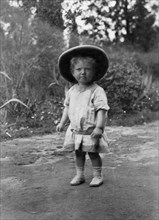 Child wearing a solatopi. Portrait of Allan Kidney as a toddler wearing a solatopi and belted dress