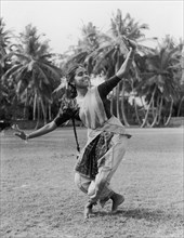 Sri Lankan tamil dancer. A young Tamil woman smiles as she performs a traditional dance outdoors.