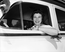 Daphne Dale in the driving seat. Dancer Daphne Dale smiles from the driver's seat of a car. She