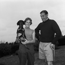 The Thornley Dyer Family. Mr Thornley Dyer leans on a golf club beside his daughter as she poses