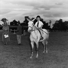 Pony competition at the SJAK show. A young boy sits astride a pony in the class two child's pony