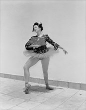 Sonja in Japanese costume. Sonja poses wearing theatrical costume comprising a tutu and ballet