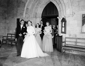 June Watkin's wedding. A wedding party leaves the church, the procession headed by bride June