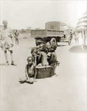 Children in bath tub. A group of semi-naked African children squash together in an empty bath tub