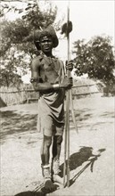 A Shilluk man. A Shilluk man pictured outdoors wears traditonal dress comprising beaded jewellery