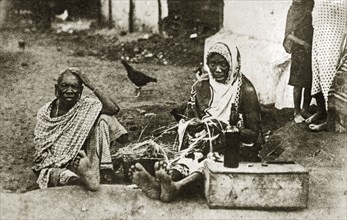 Portrait of two Mombasan women. Portrait of two African women sitting barefoot on a dirt road.