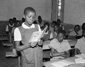 Reading out loud. Promotional shot for the East African Literature Bureau. An African schoolgirl