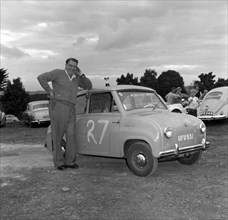 George Arkell's Goggomobil. George Arkell rests his elbow on the top of a Goggomobil car entered as
