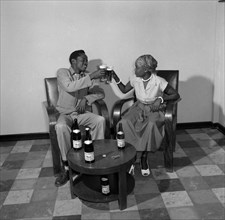 A toast to Allsopp's Pale Ale. Promotional shot for Allsop's Pale Ale. An African man and woman