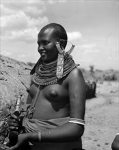 Portrait of a young Samburu woman. Portrait of a young semi-naked Samburu woman wearing elaborate
