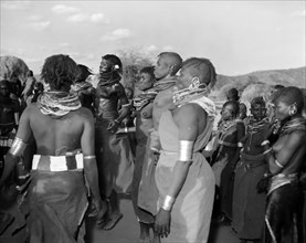 A Turkana 'ngoma'. A group of Turkana adults dance at a crowded 'ngoma'. They wear traditional