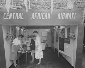 Central African Airways at the Royal Show. A woman dressed in a flight attendant's uniform shows