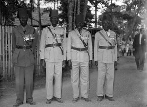Long service askaris. Four highly decorated, long service askaris (soldiers) pose for the camera