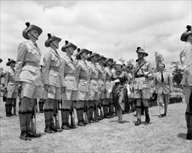 Princess Margaret inspects a Guard of Honour. European soldiers comprising a Guard of Honour stand