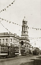 Adelaide town hall. Strings of bunting festoon the road above trams passing in front of the town