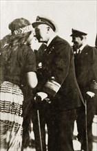Rear Admiral Brand rubs noses. Rear Admiral Sir Hubert Brand greets a Maori woman by rubbing noses