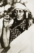 Portrait of a Maori wahine. Portrait of a Maori wahine (woman) wrapped in a patterned blanket,