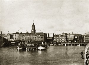 Auckland harbour. Crowds gather on the harbourside to watch the departure of the British Special