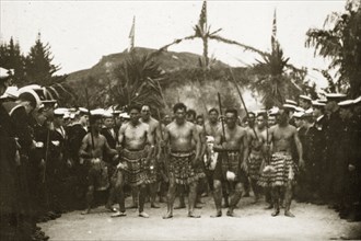 Fijian warriors. Male Fijian warriors perform a dance with spears wearing traditional beaded skirts