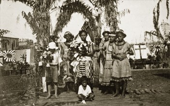 Fijian women. A group of Fijian women and children wearing traditional dress gather beneath an arch