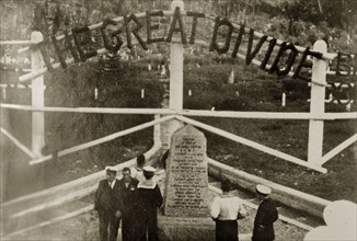 The Great Divide'. Uniformed naval personnel stand beside a stone marker indicating the division