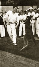 Kangaroo boxing. A crew member from HMS Hood entertains his shipmates by joining in a boxing match