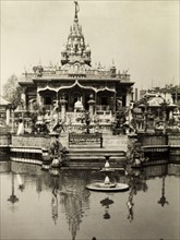Temple on the water. Steps at an ornately decorated temple lead down into a fountain pool. India,