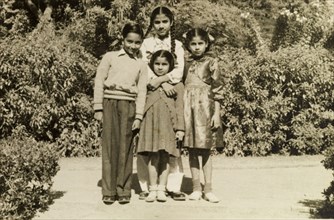 Four Indian children. Four Indian children dressed in Western-style clothing, pose obediently for