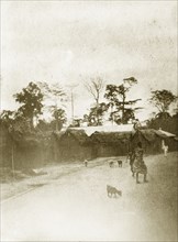 West African street. Postcard view of a west African village street. Western Africa, circa 1920.,